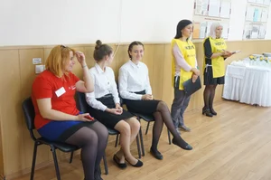 Two cute college girls wearing white blouses, skirts, pantyhose and flats sitting with crossed legs
