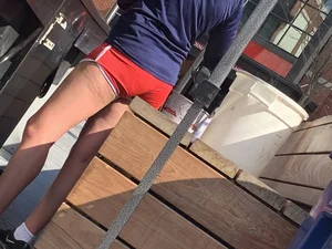 Bunch of girls in various outfits at a Cardinals baseball game