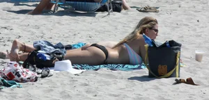 Big boobed thick blonde on the beach in a bikini
