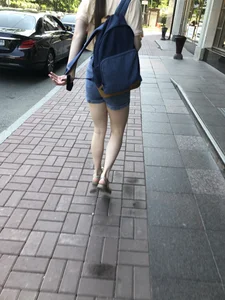 Girl with awesome pale legs in shorts wearing a backpack street creepshots
