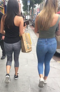 Sexy girl walking in grey patterned leggings with friend in tight jeans
