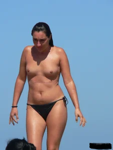 Bunch of sexy babes on the beach topless and in thong bikinis