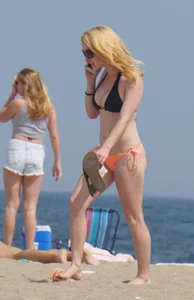Hot blonde in peach and black bikini on the beach