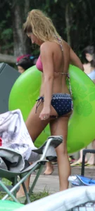 Blonde bikini girl at the pool in pink bikini top with amazing tits