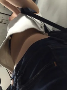 Sexy Asian showing bra under shirt and a little cleavage