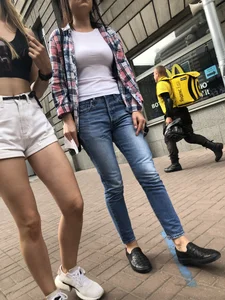 Hot Candid Girl in a Top, Shorts and Sneakers Skinny Legs Closeup Creepshots Gallery on the City Street