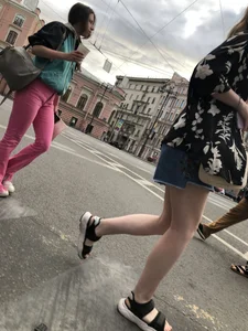 Hot pale legs of a candid girl crossing the street