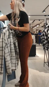 Blonde dutch shop assistent in orange cord leggings
