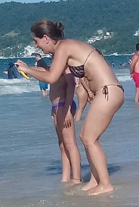Milf on the beach in a thong bikini