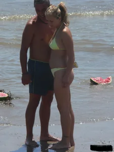 Sexy blonde on the beach in a yellow thong bikini