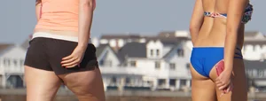 Beach babe in a blue bikini with thick friend in shorts