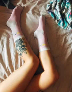 Tattooed Legs in Socks Bed Selfie