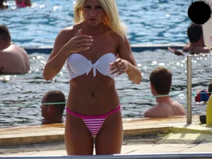 Tanned blonde looking sexy at the pool in thong