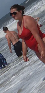 Fat chick on the beach in a red swimsuit