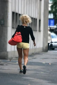 Blonde looking sexy walking in short yellow shorts