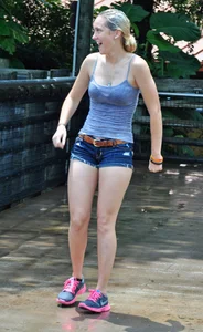 Cute blonde in denim shorts and a wet top