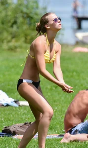 Sexy blonde girl in the park playing volleyball in her skimpy bikini