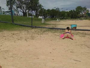 White thong brunette babe laying out on the beach with her dog