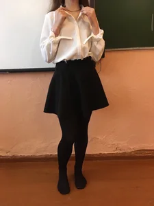Young College Girl in Black Pantyhose, a Blouse And a Skirt in a Classroom Photos