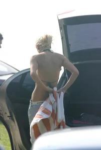 Blonde babe changing into and out of bikini and shows her tits