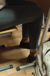 Legs in Tight Jeans and Feet in Shoes And Cute Socks, Under Desk Closeups of a College Teen in Class