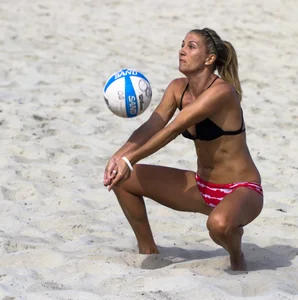 Hot girls playing beach volleyball in bikinis and shorts