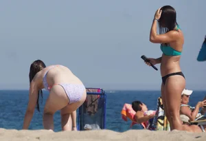 2 cute friends in bikinis on the beach