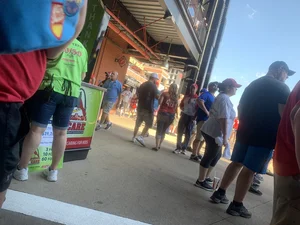 Bunch of girls in various outfits at a Cardinals baseball game