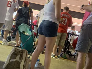 Bunch of girls in various outfits at a Cardinals baseball game