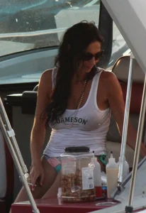 Bikini babe on a boat with a wet see through white shirt showing her tits