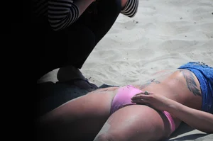 Tattooed Milf in Swimsuit Lying on the Sand with Her Feet Up Beach Creepshots Gallery