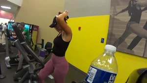 Smoking hot brunette working out at the gym in tight leggings