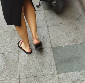 Mature Wife's Legs And Feet in Flip-Flops on the Street