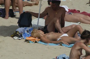 Topless girls on a beach in Barcelona