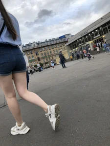 Candid Girl in Blue Denim Shorts and Sneakers Walking Down the Street - Hot Legs Crepshots Collection