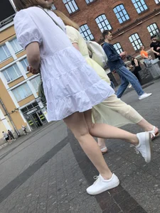 Young candid girl in a white dress, hot legs