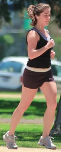 Cute girl running in short shorts
