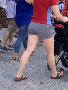 Bunch of girls in various outfits at a Cardinals baseball game