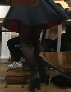 College Teen in a Skirt and Black Pantyhose Closeup