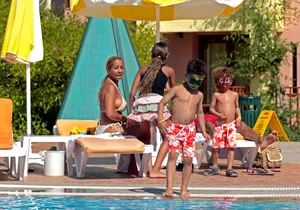 Big boobed blonde milf dancing by the pool in a bikini
