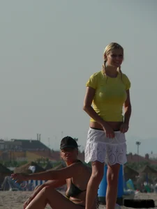 Blonde on the beach topless with big boobs and in a black thong