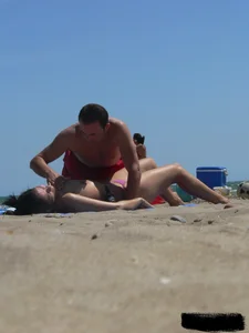 Purple thong topless lady on the beach gets oiled up by her husband
