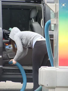 Girls cleaning their cars in jeans and pants