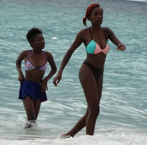 Candid black family, milf and teens on the beach in bikinis
