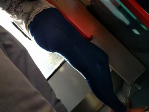 Train girl in tight jeans with a nice ass standing around