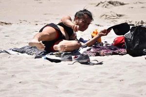 Beach girl can't keep her tits in her bikini