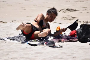 Beach girl can't keep her tits in her bikini