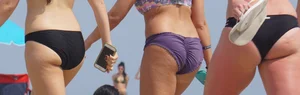 3 sexy girls with nice asses walking on the beach in bikinis