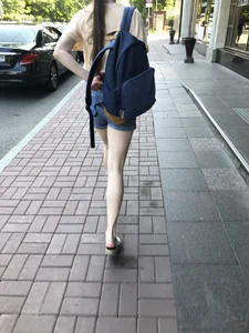 Girl with awesome pale legs in shorts wearing a backpack street creepshots