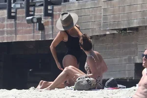 Ashley Tisdale in cheetah print swimsuit on the beach in Malibu